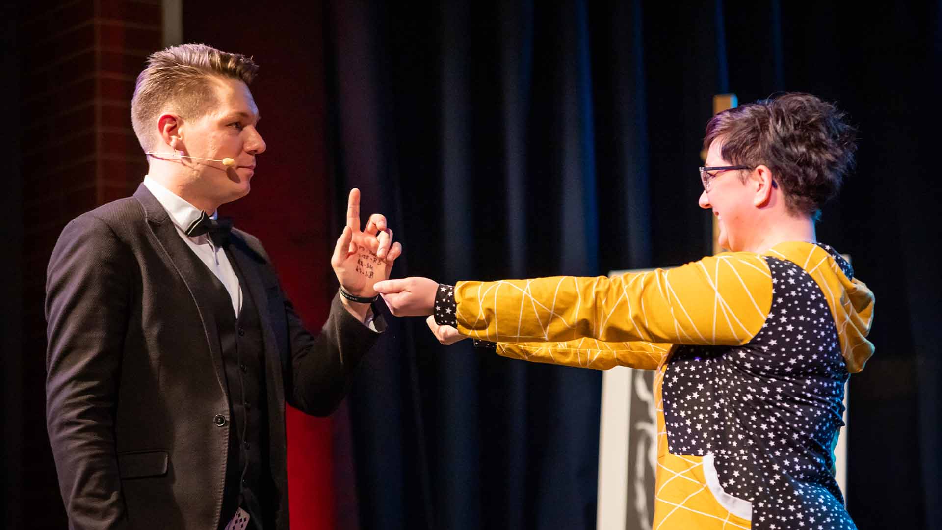 Thomas versucht, bei einer Zuschauerin zu erraten, in welcher Hand sie etwas hält